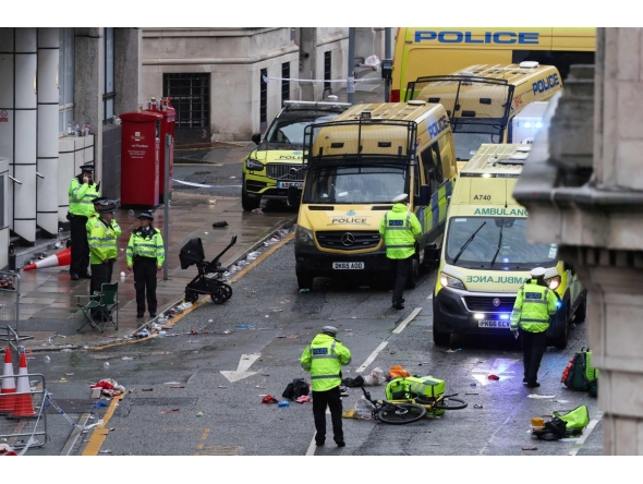 Police officers investigate the scene of an incident in Water Street, on the sidelines of an open-top bus victory parade for Liverpool's Premier League title win, in Liverpool, north-west England on May 26, 2025. (Photo by Darren Staples / AFP)

