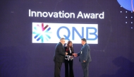 A QNB official receiving the award at Red Hat Summit 2025.