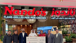 Nando’s representatives handing over the cheque to QCS representatives, who in turn presented a trophy to the Nando’s team.