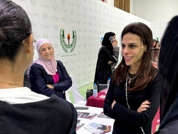 Students interacting with university representatives. 