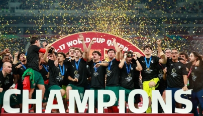 AFP photo of Portugal's players celebrate with the trophy on the podium after the FIFA U17 World Cup final football match between Portugal and Austria at Khalifa International Stadium in Al-Rayyan on November 27, 2025.