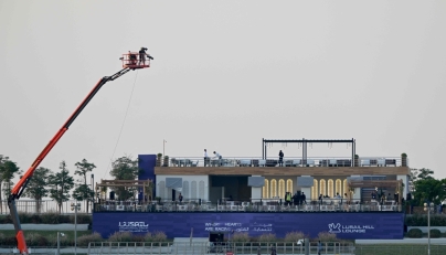 Workers prepare a stand at the Lusail International Circuit ahead of the Formula One Qatar Grand Prix in Lusail on November 27, 2025. (Photo by Mahmud Hams / AFP)