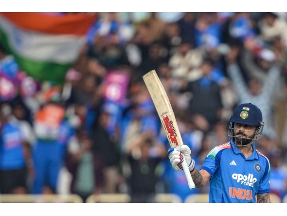 India's Virat Kohli celebrates after scoring a half-century (50 runs) during the first one-day international (ODI) cricket match at the JSCA International Stadium in Ranchi on November 30, 2025. (Photo by Dibyangshu Sarkar / AFP) 