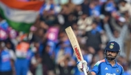 India's Virat Kohli celebrates after scoring a half-century (50 runs) during the first one-day international (ODI) cricket match at the JSCA International Stadium in Ranchi on November 30, 2025. (Photo by Dibyangshu Sarkar / AFP) 