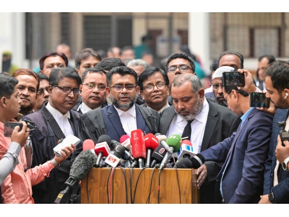 prosecutor for the Anti-Corruption Commission Khan Mainul Hasan (C), addresses the media at a court premises in Dhaka on December 1, 2025. (Photo by Munir Uz Zaman / AFP)