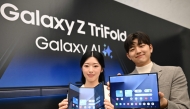Promoters show Samsung Galaxy Z TriFold smartphones during a launch event at a Samsung store in Seoul on December 2, 2025. (Photo by Jung Yeon-je / AFP)