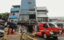 Firefighters are seen at the scene where they have extinguished a fire that killed at least 20 people at a seven-storey building in central Jakarta on December 9, 2025. (Photo by Synatria Respati / AFP)