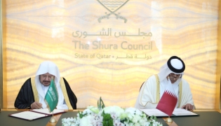 Speaker of the Shura Council H E Hassan bin Abdullah Al Ghanim and Speaker of the Shura Council of Saudi Arabia H E Sheikh Dr. Abdullah bin Mohammed bin Ibrahim Al Sheikh signing an agreement to enhance cooperation between the two councils.