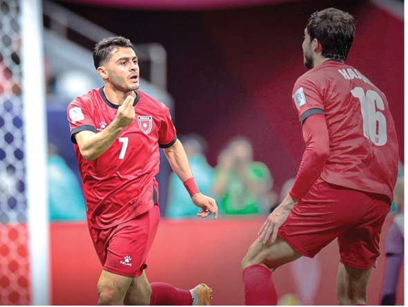 Jordan's Mohammad Abu Zraiq (left) celebrates after scoring a goal.