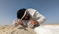 Ferhan Sakal from Qatar Museums applies plaster bandages to protect the fossils of a 21-million-year-old sea cow from the Al Maszhabiya site in southwestern Qatar. Picture: Nicholas D. Pyenson / Smithsonian Institution
