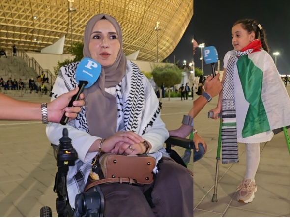 A Palestinian woman and child injured during the Gaza war speak during the Palestine-Saudi Arabia match of the FIFA Arab Cup Qatar at Lusail Stadium on Thursday. 