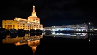 The Abdullah Bin Zaid al-Mahmoud Islamic Cultural Centre is reflected in a pool of water on a rainy day in the Qatari capital Doha on December 16, 2025. Photo by Mahmud HAMS / AFP