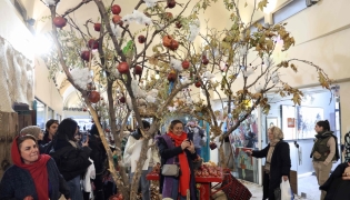 Iranians celebrate with Yalda decoration in northern Tehran on December 20, 2025, in preparation for the annual festival of Yalda. (Photo by -STR / AFP)