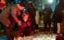 People react next to a makeshift memorial at the playground of Precko primary school, following a stabbing attack at the school which left one dead and several injured, in Zagreb, on December 20, 2024. (Photo by DAMIR SENCAR / AFP)

