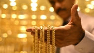 (Files) A salesman displays gold chains at a jewellery store in Bengaluru on September 17, 2025. (Photo by Idrees Mohammed / AFP)