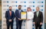 Ahlibank official receiving the ISO certification.