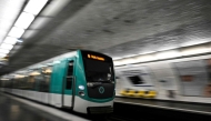This photograph shows a subway train entering a metro station in Paris on April 1, 2024. Photo by JULIEN DE ROSA / AFP