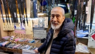 Yau Yiu-wai, 73, one of the few remaining umbrella repairmen in Hong Kong, poses poses for a photo in Hong Kong's Sham Shui Po district on December 26, 2025. Photo by Tommy WANG / AFP