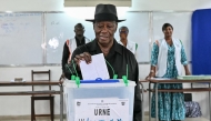 Ivory Coast's President Alassane Ouattara casts his ballot at a polling station at the Lycee Saint-Marie in Cocody, Abidjan, on December 27, 2025 during Ivory Coast's legislative elections. (Photo by SIA KAMBOU / AFP)
