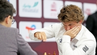 Norway's Magnus Carlsen (right) competes against Yagiz Kaan Erdogmus of Turkiye.