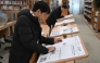 A visitor reads Rodong Sinmun (front), North Korea's top newspaper, at the National Library of Korea in Seoul on January 2, 2026. Photo by Jung Yeon-je / AFP