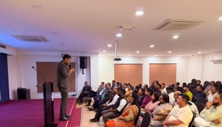 Participants listen to the speaker during a workshop session.