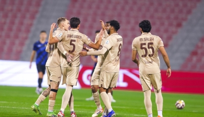 Al Rayyan's Roger Guedes (left) celebrates with teammates.