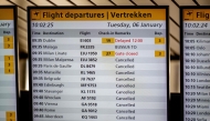 This photograph shows a flight departures information board displaying numerous cancellations at the Schiphol Airport on January 6, 2026 as hundreds of flights have been cancelled again at the airport due to snowfall. (Photo by Robin Utrecht / ANP / AFP) / Netherlands OUT