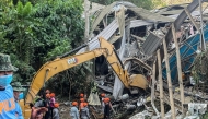 Search and rescue teams look for people after a landslide at the landfill in Barangay Binaliw, Cebu City on January 9, 2026. (Photo by Cheryl Baldicantos / AFP)