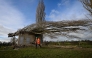 A worker secures the area around a fallen tree on a water borehole, following the passage of the storm Goretti, in Saint-Gabriel-Brecy, near Martragny, northwestern France. (Photo by Lou Benoist / AFP)