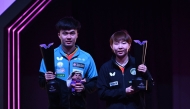Lin Yun-ju (left) of Chinese Taipei, and  Macau's Zhu Yuling pose with their trophies after winning the singles titles yesterday. AFP