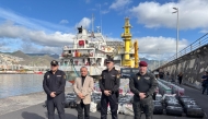 This undated handout photo released on January 12, 2026 by Spanish National Police shows Spanish police posing in front of some of the nearly 10 tons of cocaine seized on a cargo ship in Spain's Canary Islands. (Photo by Handout / Spanish National Police / AFP)