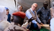 United Nations (UN) High Commissioner for Refugees, Barham Salih (2nd R), talks with a Sudanese refugee, in Farchana, Ouaddai, on January 14, 2026. (Photo by Joris Bolomey / AFP)