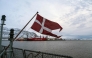The Danish flag flies form the deck of the HDMS Knud Rasmussen Royal Danish Navy patrol vessel, moored at the harbour in Nuuk, Greenland on January 16, 2026. (Photo by Alessandro Rampazzo/ AFP)