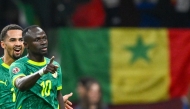 Senegal's forward #10 Sadio Mane celebrates his goal with Senegal's forward #13 Iliman Ndiaye during the Africa Cup of Nations (CAN) semi-final between Senegal and Egypt at the Grand stadium in Tangiers on January 14, 2026. (Photo by Sebastien Bozon / AFP)
