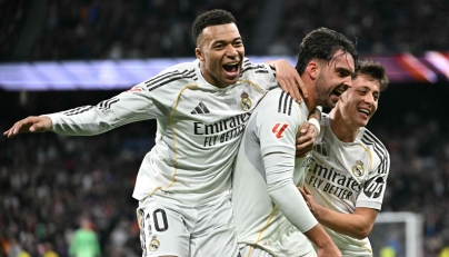 Real Madrid's Spanish defender #17 Raul Asencio (C) celebrates with Real Madrid's French forward #10 Kylian Mbappe (L) and Real Madrid's Turkish midfielder #15 Arda Guler after scoring his team's second goal during the Spanish league football match between Real Madrid CF and Levante UD at Santiago Bernabeu Stadium in Madrid on January 17, 2026. (Photo by Javier SORIANO / AFP)