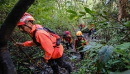 Joint search and rescue teams climb towards the suspected crash site of an Indonesia Air Transport turboprop plane that lost contact a day earlier while flying from Yogyakarta to Makassar, in the Bulusaraung Mountains, South Sulawesi, Indonesia, January 18, 2026. Photo by Muchtamir / AFP