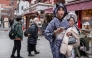 People visit a shopping street in Asakusa district near Sensoji Temple, a popular tourist location in Tokyo on January 20, 2026. (Photo by Philip Fong / AFP)
 