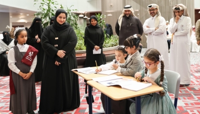 Officials watch pupils work during activities marking the education day.   
