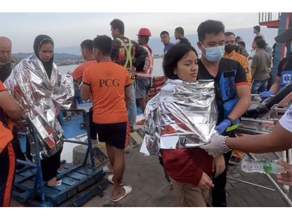This screen grab from video footage taken and received on January 26, 2026, from Governor Mujiv Hataman shows rescuers assisting survivors of the sunken MV Trisha Kerstin 3 at a port in Isabela, Basilan province. A ferry with more than 350 people onboard sank on January 26 morning in choppy seas off the southern Philippines, leaving at least 15 dead and 28 still missing, the coast guard said. (Photo by Handout / Governor Mujiv Hataman / AFP)
