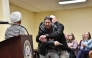 A man is tackled after spraying an unknown substance at US Representative Ilhan Omar (D-MN) (L) during a town hall she was hosting in Minneapolis, Minnesota, on January 27, 2026. (Photo by Octavio Jones / AFP)