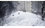 People cross a street used for temporary snow storage in central Moscow on January 29, 2026. (Photo by Alexander NEMENOV / AFP)
