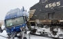 This handout image released by the Gastonia Police Department shows a semi-truck struck by a freight train at the intersection of Poplar Street and Airline Avenue in Gastonia, north of downtown Charlotte, North Carolina on January 31, 2026 amid a winter snowstorm affecting the region. Photo by Gastonia Police Department / AFP