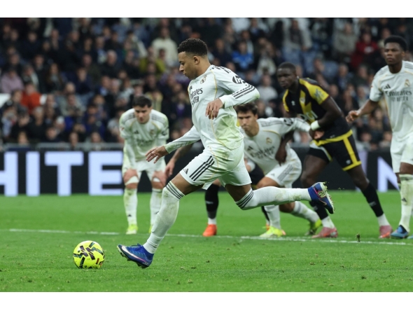 Real Madrid's French forward #10 Kylian Mbappe scores his team's second goal from the penalty spot during the Spanish league football match between Real Madrid CF and Rayo Vallecano at the Santiago Bernabeu stadium in Madrid on February 1, 2026. (Photo by Thomas COEX / AFP)