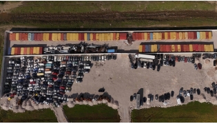This aerial drone photograph shows containers of toxic industrial waste stored at a controlled site near the port city of Durres on November 8, 2025. (Photo by Adnan Beci / AFP)