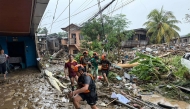 Rescuers evacuate a woman after Tropical Storm Penha hit the area in Iligan, Lanao del Norte province on February 6, 2026. (Photo by Merlyn Manos / AFP)