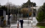 Two people observe a flooded area at Las Pachecas settlement in Jerez, southern Spain, on February 5, 2026, amid Storm Leonardo. (Photo by Cristina Quicler / AFP)
