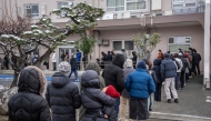 People queue up at a polling station to vote during the House of Representatives election in Kawasaki, Kanagawa prefecture on February 8, 2026. (Photo by Yuichi Yamazaki / AFP)