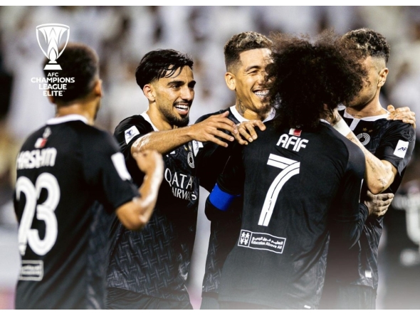 Al Sadd's players celebrate a goal.