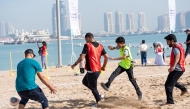 Participants playing football at Katara beach.